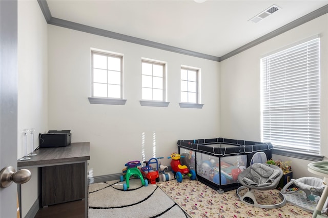 game room with visible vents, baseboards, and ornamental molding