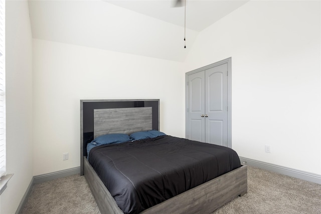 carpeted bedroom featuring baseboards and lofted ceiling