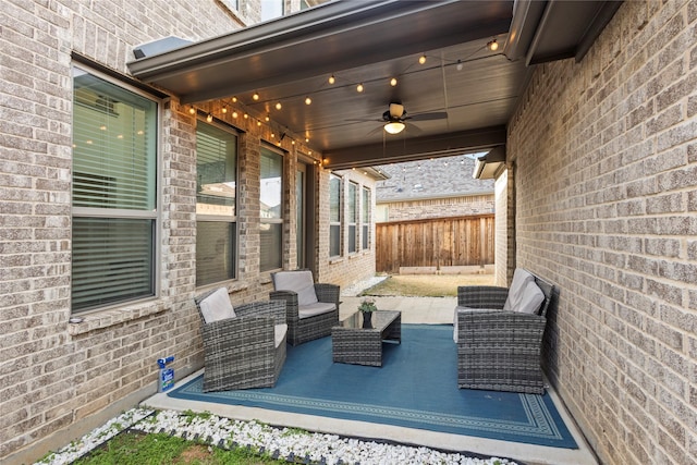 view of patio with an outdoor living space, fence, and ceiling fan