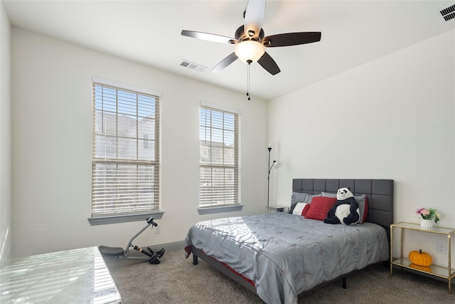 carpeted bedroom with visible vents and ceiling fan