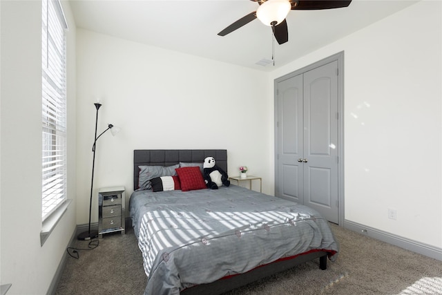 carpeted bedroom featuring multiple windows, baseboards, and ceiling fan