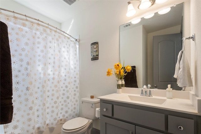 bathroom featuring vanity, a shower with shower curtain, toilet, and visible vents