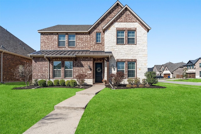 craftsman-style home with a front yard, a standing seam roof, stone siding, brick siding, and metal roof