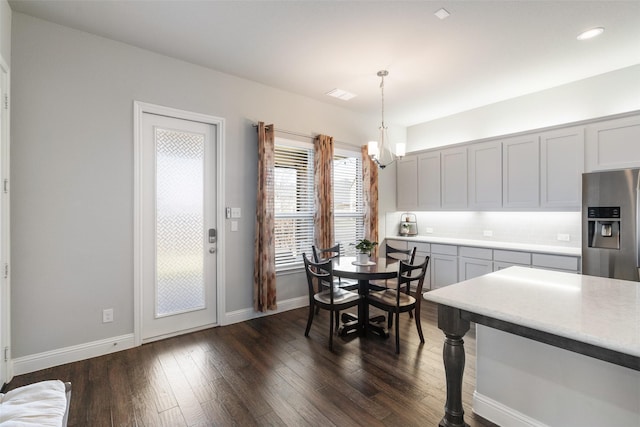 dining room featuring baseboards, visible vents, recessed lighting, dark wood-type flooring, and a notable chandelier