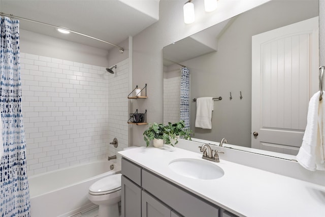 bathroom featuring shower / bath combo with shower curtain, toilet, and vanity