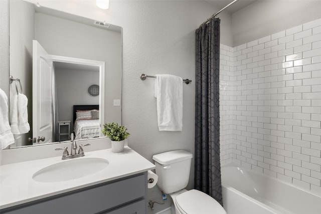 ensuite bathroom featuring visible vents, shower / bath combo with shower curtain, toilet, ensuite bathroom, and vanity