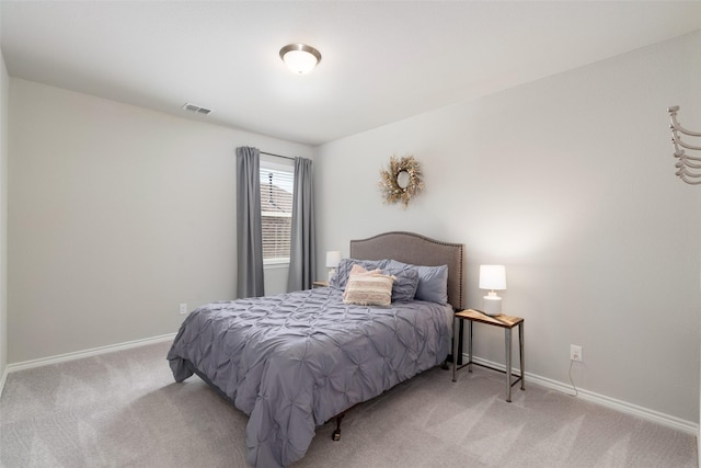 bedroom featuring light colored carpet, visible vents, and baseboards