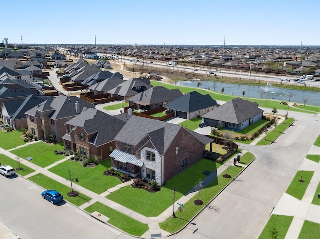 drone / aerial view with a residential view and a water view