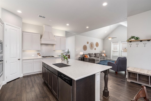 kitchen with visible vents, custom exhaust hood, a sink, light countertops, and appliances with stainless steel finishes