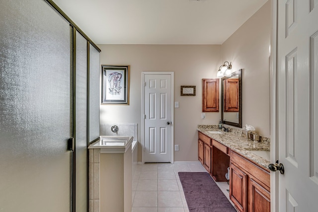 full bath featuring tile patterned floors, a garden tub, a sink, a shower stall, and double vanity