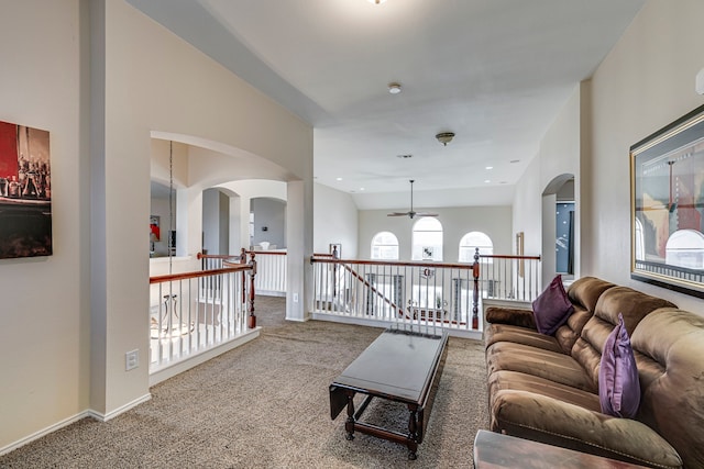 living room with baseboards, recessed lighting, arched walkways, ceiling fan, and carpet flooring