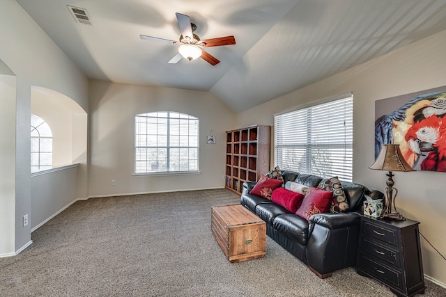 carpeted living area featuring visible vents, a wealth of natural light, and ceiling fan