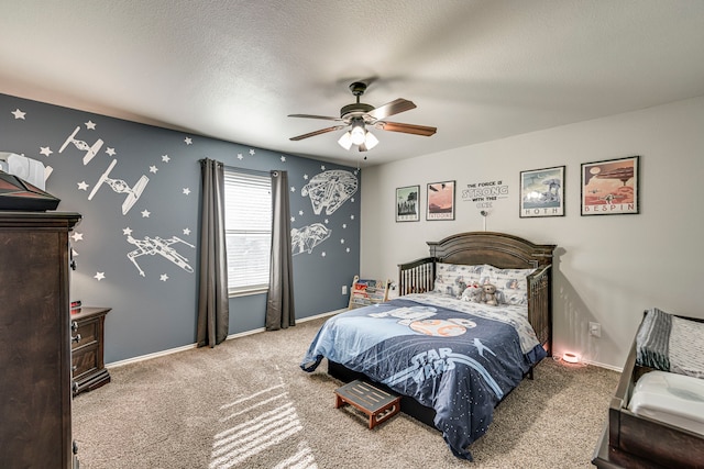 bedroom featuring carpet flooring, a ceiling fan, baseboards, and a textured ceiling