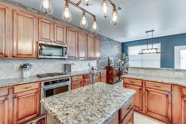 kitchen featuring decorative backsplash, light stone countertops, visible vents, and appliances with stainless steel finishes