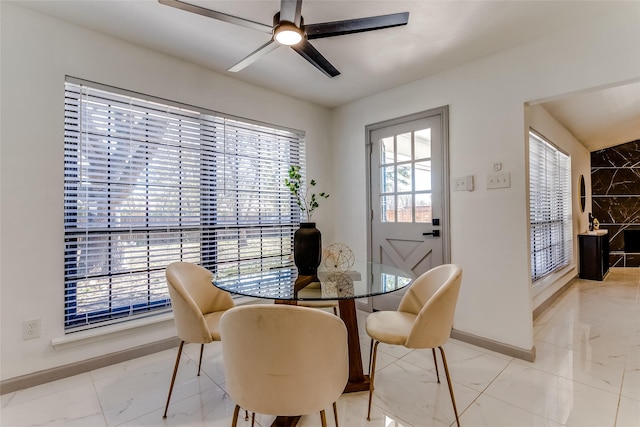 dining room with baseboards, marble finish floor, and a ceiling fan