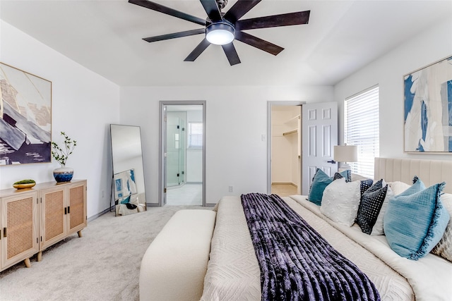 bedroom with connected bathroom, light carpet, baseboards, and ceiling fan