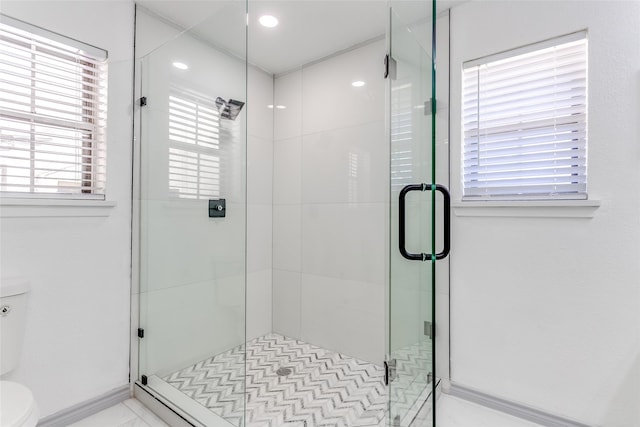 bathroom with toilet and a shower stall