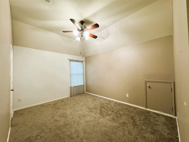 empty room with baseboards, carpet floors, a ceiling fan, and vaulted ceiling