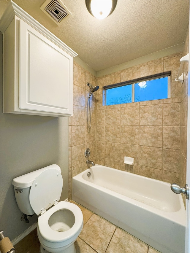 bathroom featuring visible vents, toilet, a textured ceiling, shower / tub combination, and tile patterned flooring