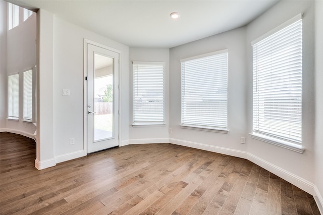 interior space with baseboards and wood finished floors