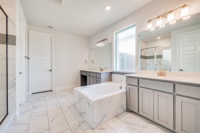 bathroom with visible vents, a stall shower, a sink, a garden tub, and marble finish floor