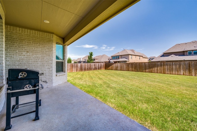 view of yard featuring a patio area, a residential view, and a fenced backyard