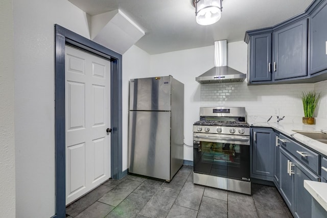 kitchen with light stone countertops, tasteful backsplash, appliances with stainless steel finishes, and wall chimney exhaust hood