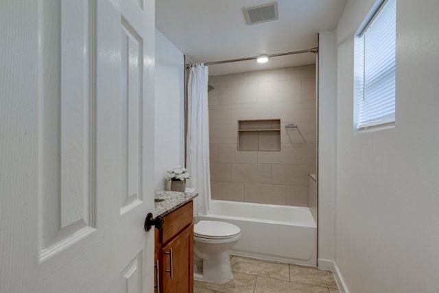 full bathroom featuring vanity, visible vents, shower / bath combo, tile patterned floors, and toilet