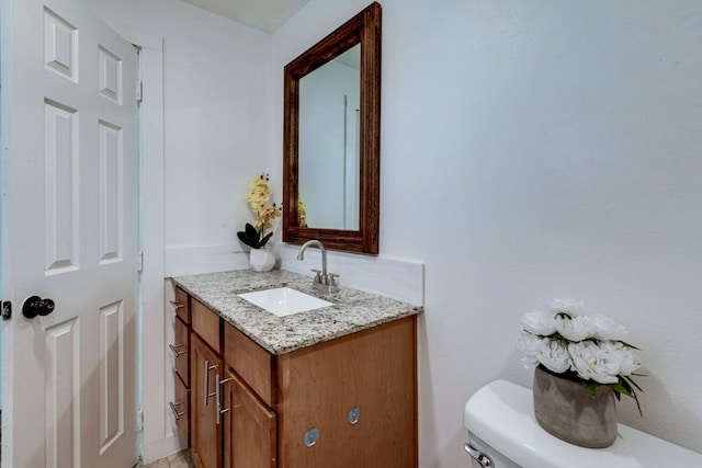 bathroom with toilet and vanity