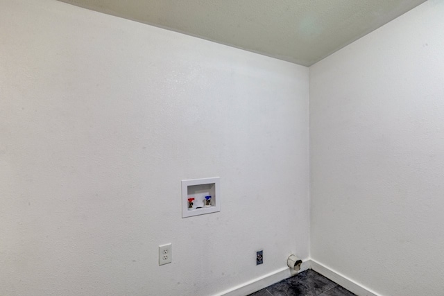 washroom featuring baseboards, hookup for a washing machine, and laundry area