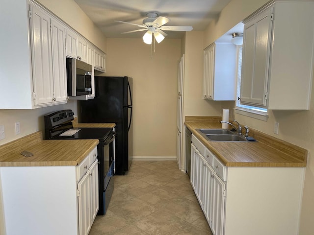 kitchen with a ceiling fan, a sink, light countertops, appliances with stainless steel finishes, and white cabinetry