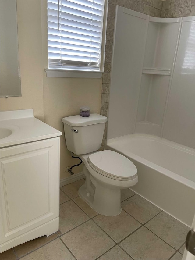 bathroom featuring baseboards, toilet, shower / bathing tub combination, tile patterned floors, and vanity