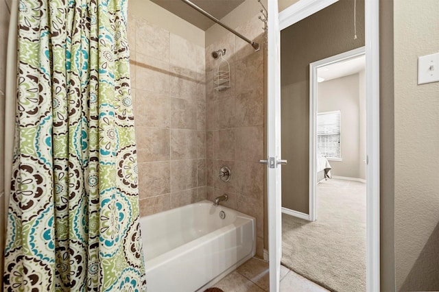 bathroom featuring tile patterned floors, baseboards, and shower / tub combo with curtain