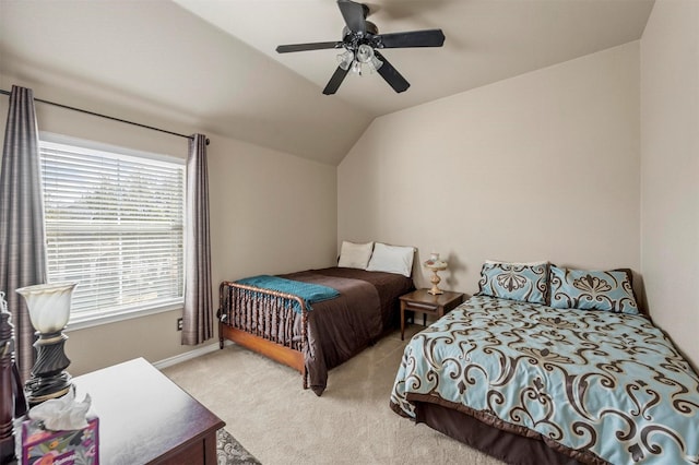 bedroom with lofted ceiling, a ceiling fan, and light carpet