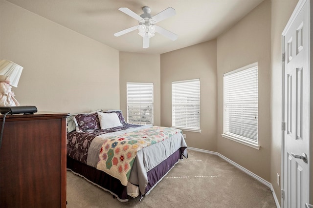 bedroom with light carpet, ceiling fan, and baseboards