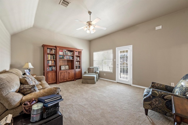 living room featuring visible vents, a ceiling fan, baseboards, light colored carpet, and vaulted ceiling