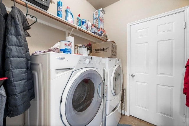 clothes washing area featuring washer and dryer, laundry area, and tile patterned flooring