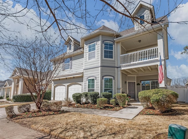 view of front of house featuring a garage and a balcony