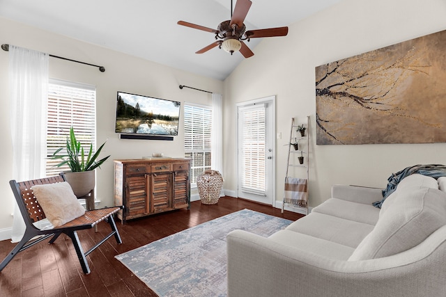 living area featuring hardwood / wood-style floors, lofted ceiling, baseboards, and ceiling fan