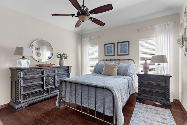 bedroom with baseboards, dark wood-type flooring, and a ceiling fan