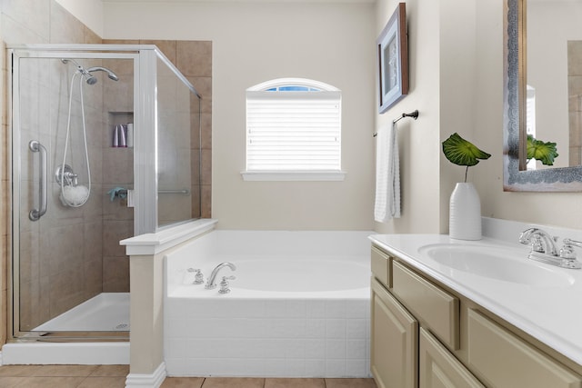 full bathroom featuring tile patterned flooring, a bath, vanity, and a stall shower