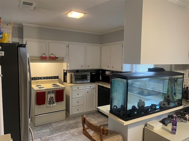 kitchen with white electric stove, visible vents, white cabinetry, and freestanding refrigerator