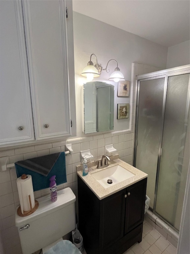 2039 Lovers Ln, Shreveport, LA 71105 - full bathroom with tile walls, vanity, a shower stall, tile patterned floors, and a wainscoted wall