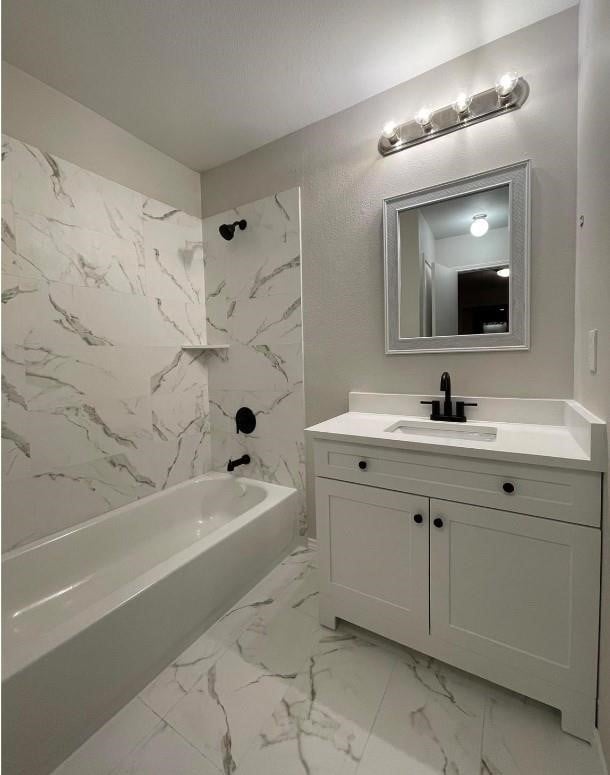 full bathroom featuring vanity, marble finish floor, and shower / washtub combination