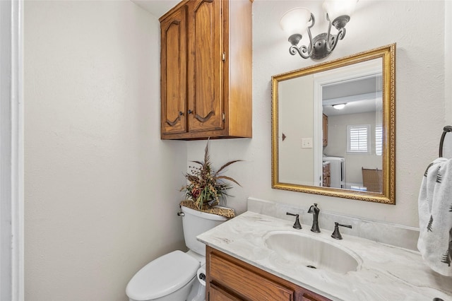 half bathroom with vanity and toilet