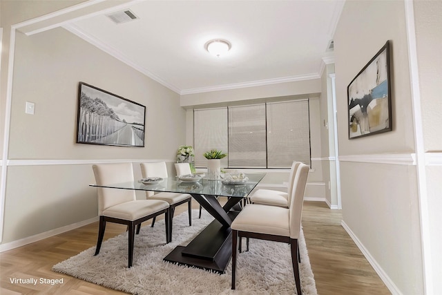 dining area featuring visible vents, parquet floors, baseboards, and ornamental molding