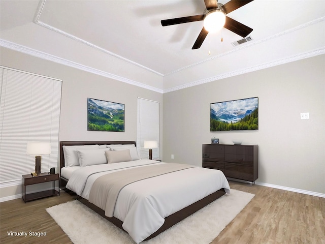 bedroom featuring crown molding, light wood-style flooring, baseboards, and visible vents