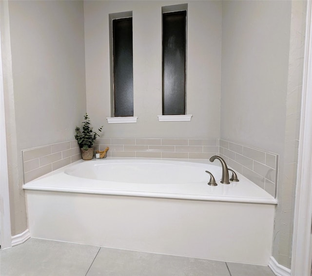 full bathroom with tile patterned flooring and a garden tub