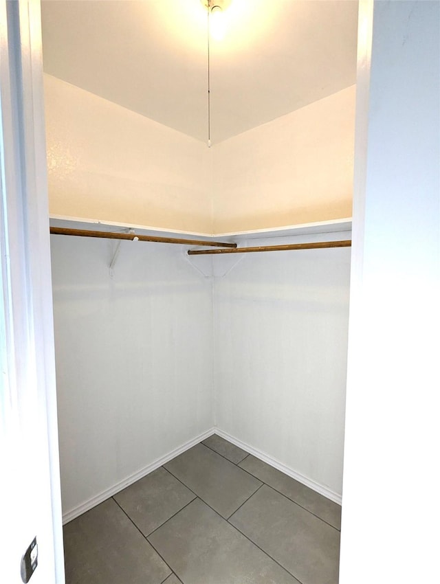 walk in closet featuring tile patterned flooring