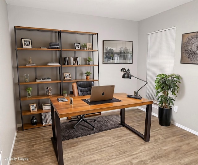 office area with wood finished floors and baseboards